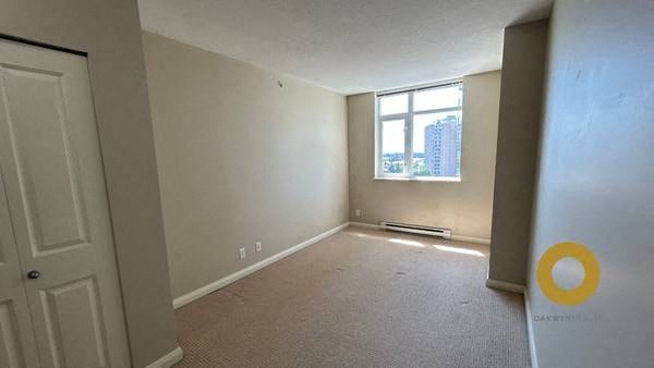 an empty room with a window and a door