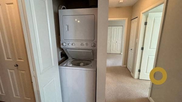 a white washer and dryer in a hallway of a house