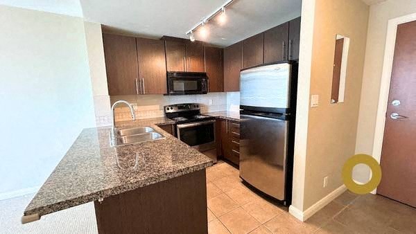 a kitchen with stainless steel appliances and a granite counter top