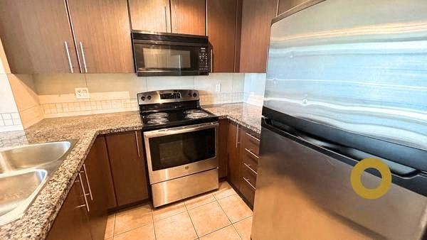 a kitchen with a stove and a refrigerator