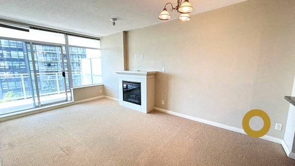 a living room with a fireplace and a large window