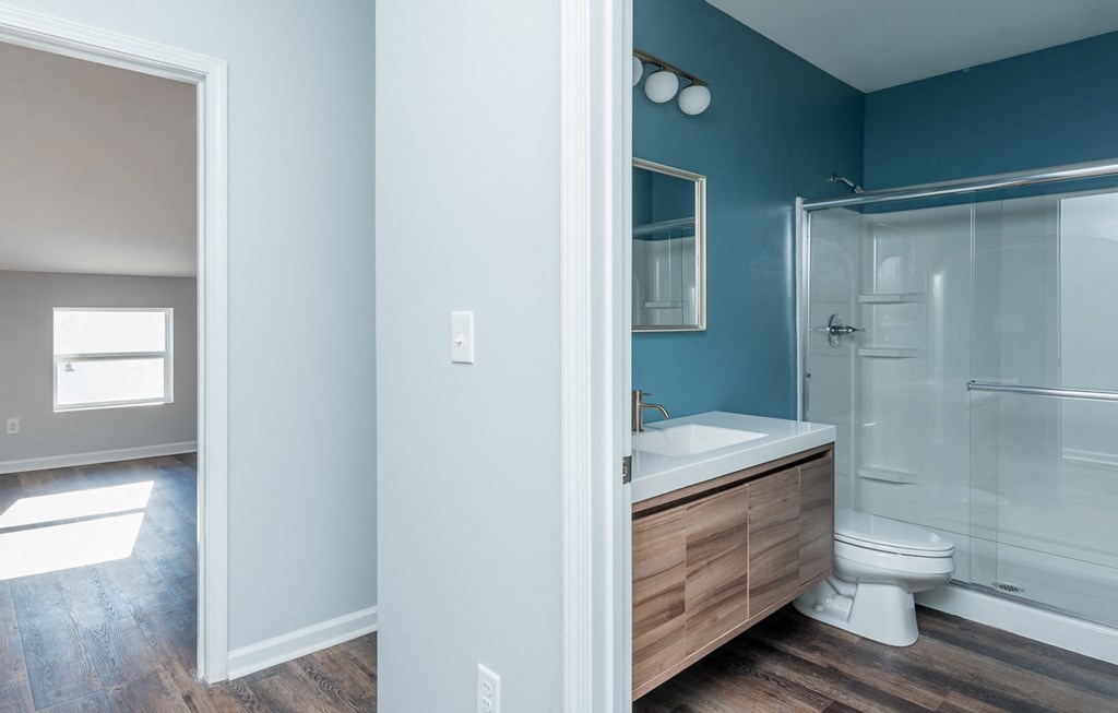 a bathroom with a toilet and a sink and a shower