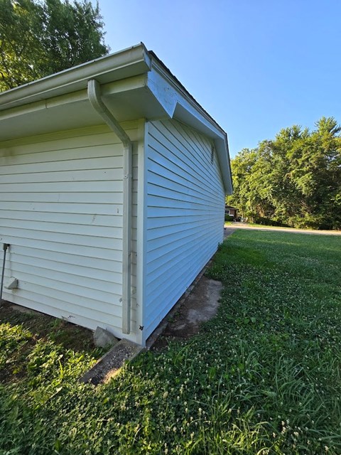 a small white church building in the grass