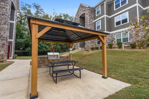 a patio with a picnic table and a gazebo