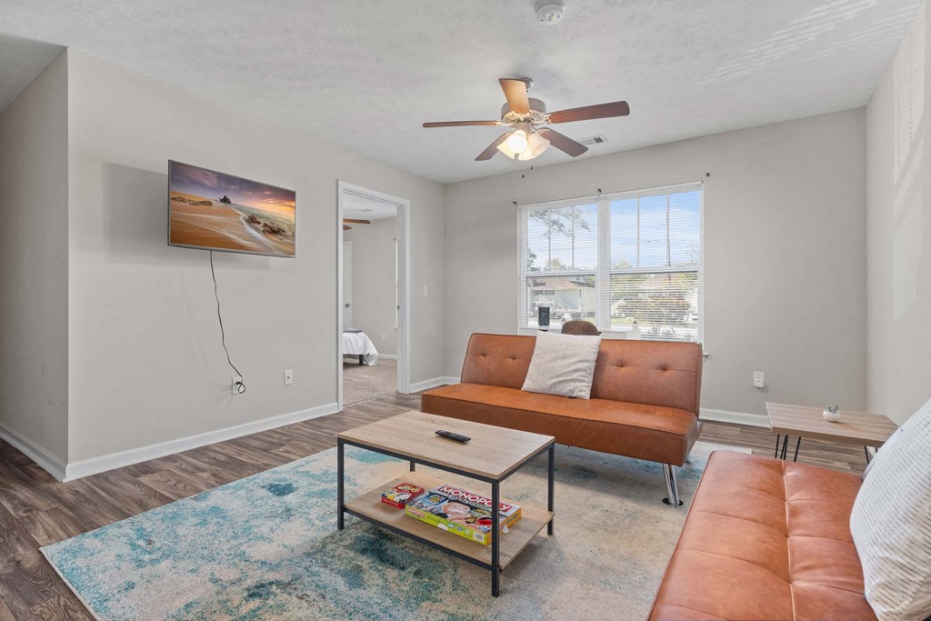 a living room with a couch and a ceiling fan