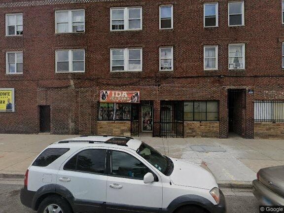 a white car parked in front of a brick building