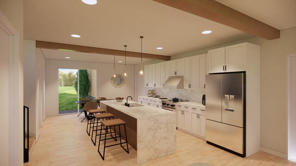 a large kitchen with white cabinets and a marble counter top
