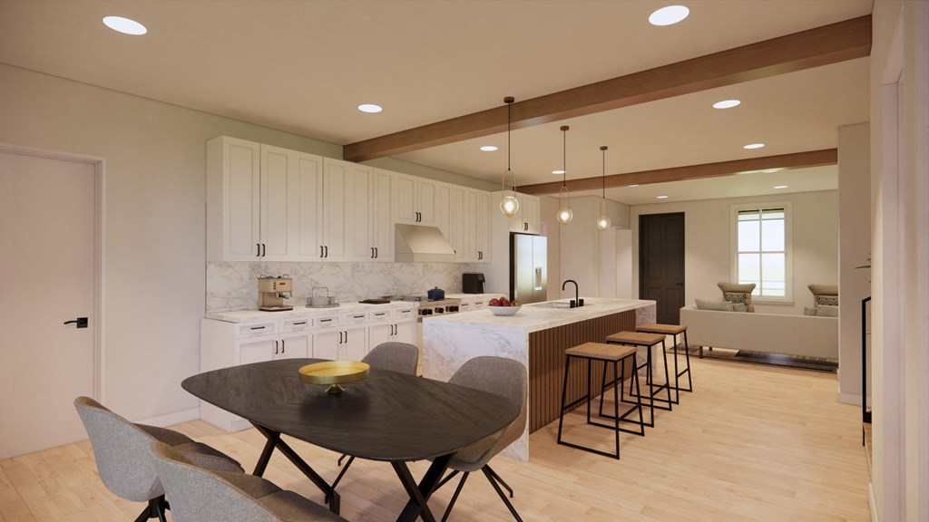 a kitchen with white cabinets and a table and chairs