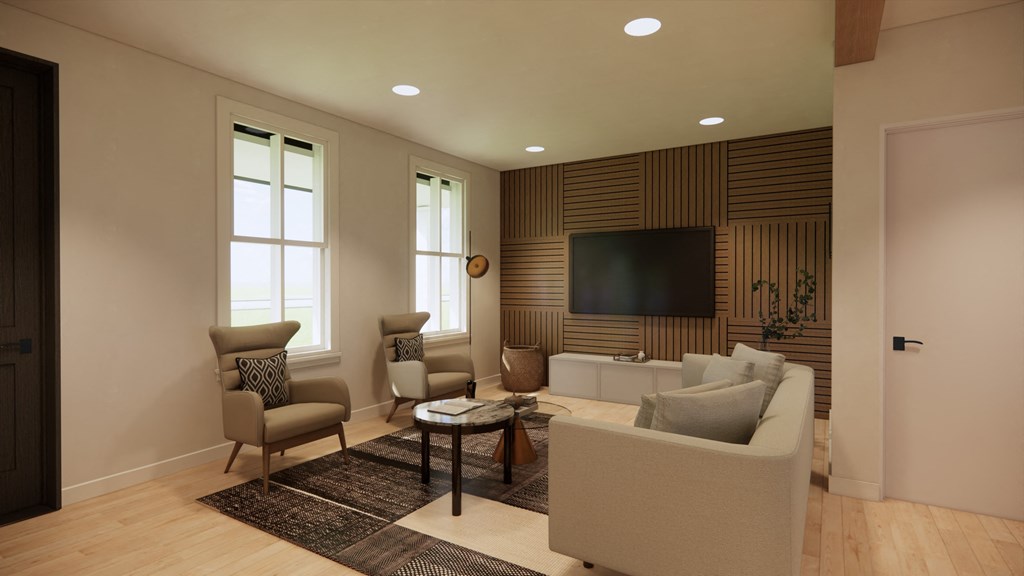 a living room with a couch and chairs and a television