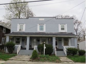 a blue house with a porch and stairs
