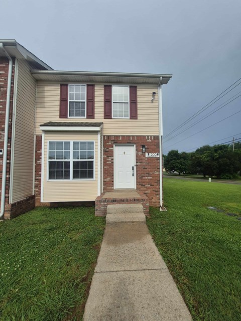 A house with a red door and a window with red shutters.