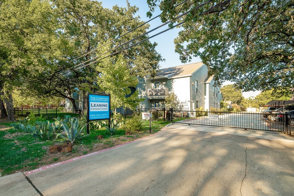 a house with a fence and a sign in front of it