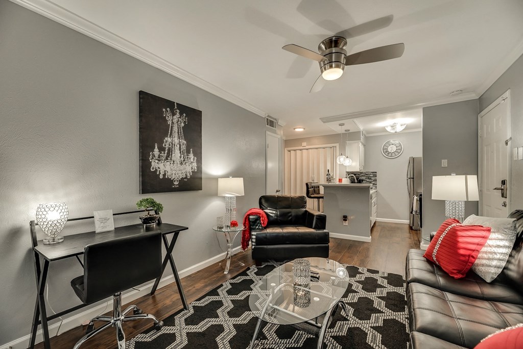 a living room with gray walls and a ceiling fan