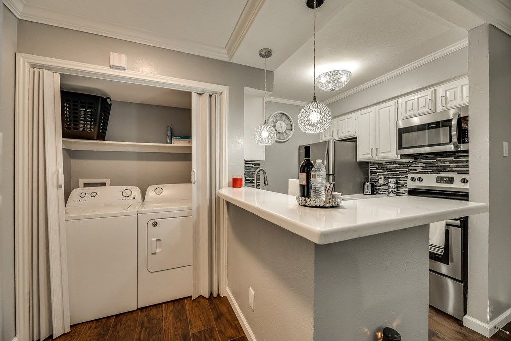 a kitchen with white appliances and a counter top