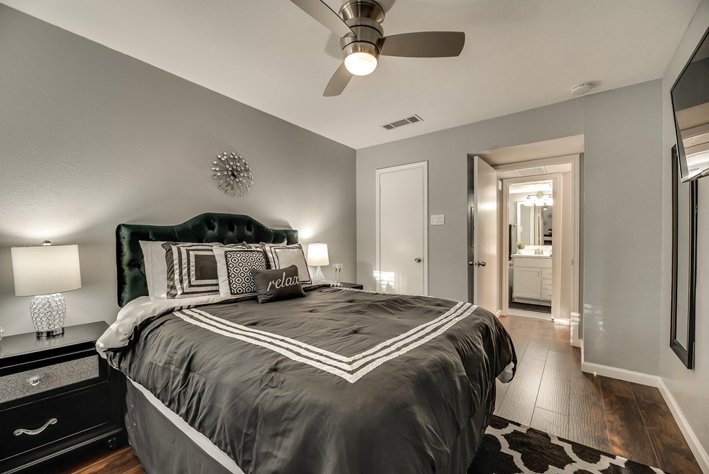 a bedroom with a bed and a ceiling fan