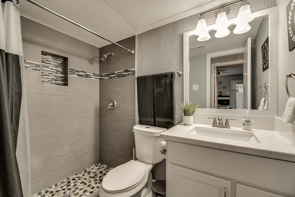 a bathroom with a toilet sink and shower