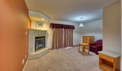 a living room with a fireplace and a red couch