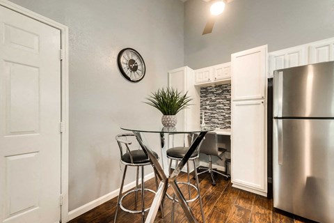 a kitchen with a table and a refrigerator