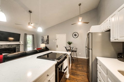 a kitchen with an island and a stove and a refrigerator