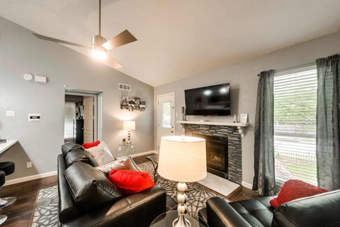 a living room with leather furniture and a fireplace