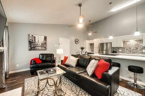 a living room with a leather couch and a table