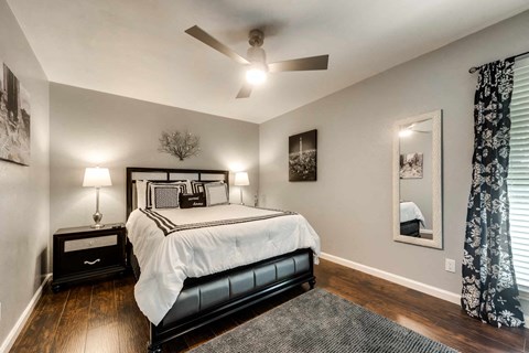 a bedroom with a bed and a ceiling fan