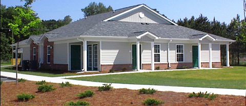 a small house with a front porch and a lawn