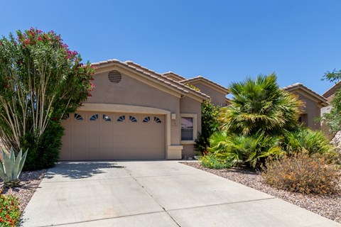 A house with a brown garage door and a driveway.