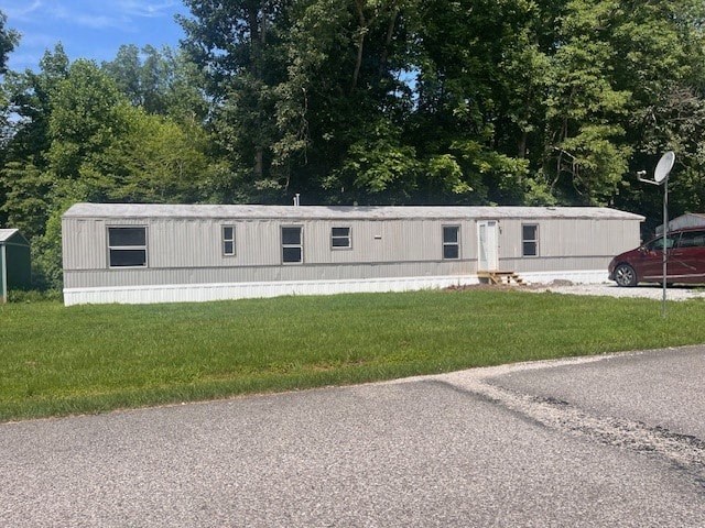 a white building with a red car parked in front of it