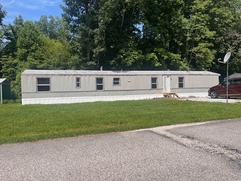 a white building with a red car parked in front of it