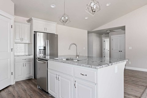 a kitchen with white cabinets and a counter top