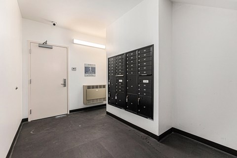 A black control panel with white numbers and letters is on a white wall.