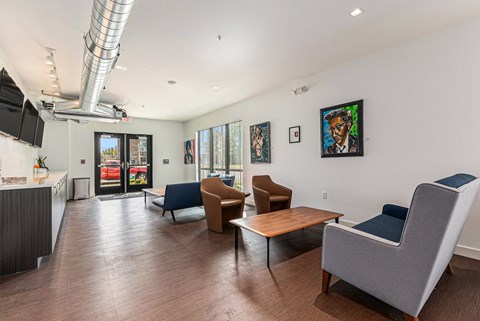 A living room with a grey couch and a wooden table.