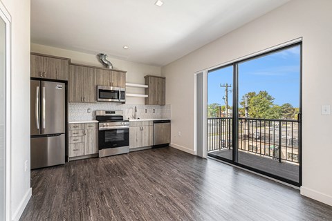 A kitchen with a refrigerator, oven, and microwave.