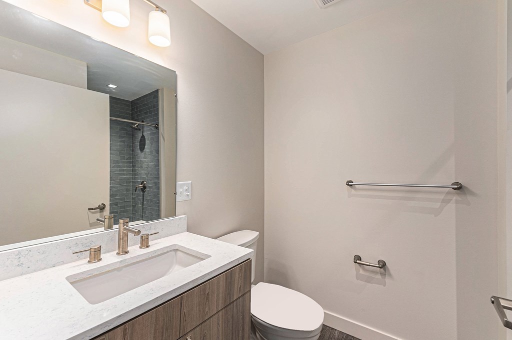 A white bathroom with a toilet and sink.