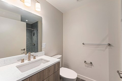 A white bathroom with a toilet and sink.
