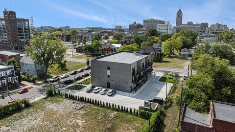 A cityscape with a large building in the foreground and a skyline in the background.