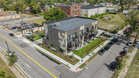 A modern building with a parking lot in front.