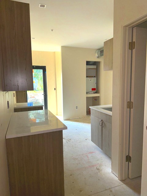 A kitchen under construction with a counter and cabinets.