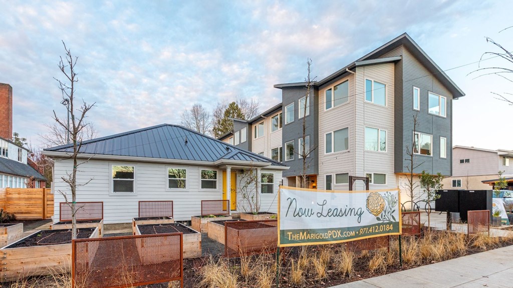 a row of houses with a sign in front of them