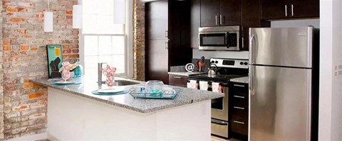a kitchen with a counter and a refrigerator