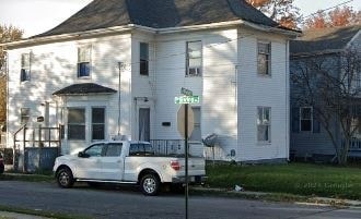 a white truck parked in front of a white house