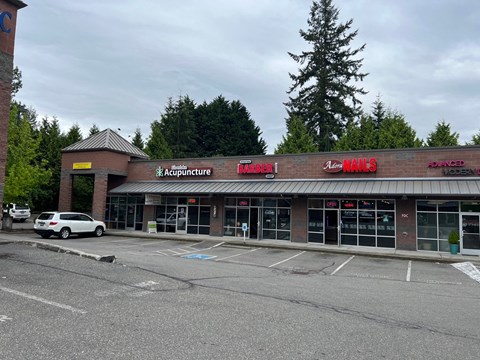 the front of a supermarket with a parking lot