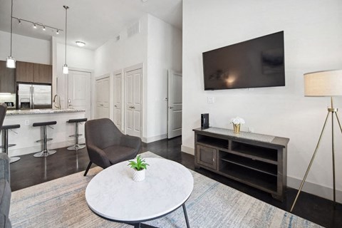 a living room with a table and a television