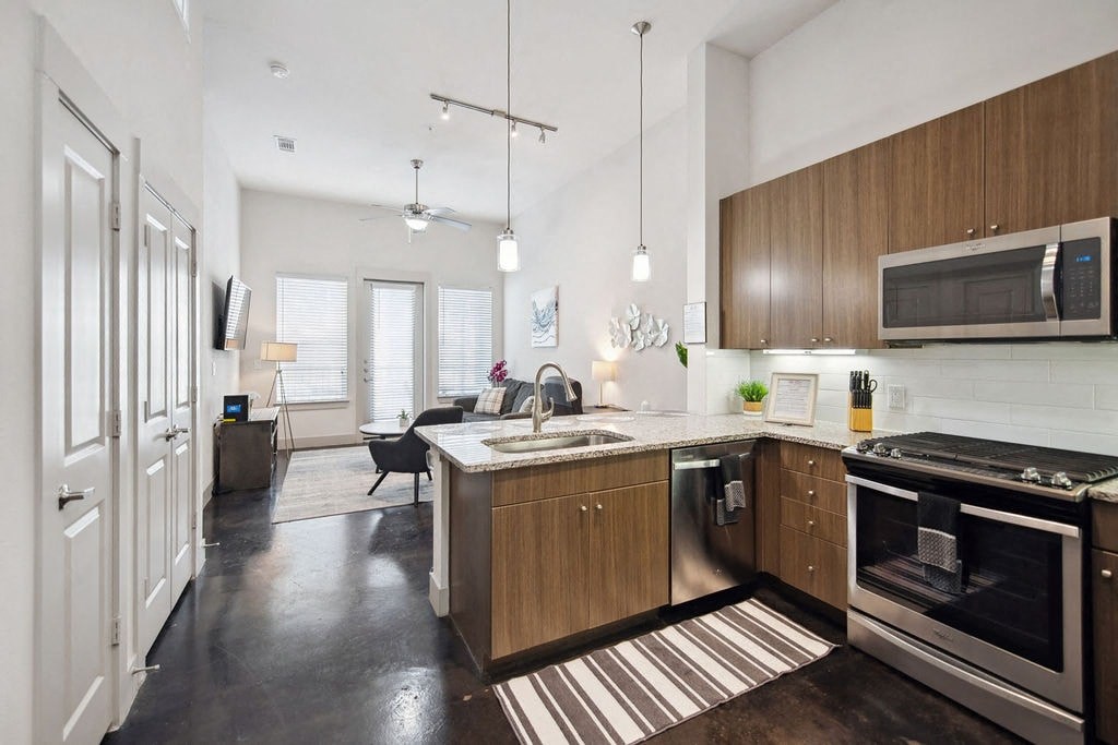 a kitchen with wooden cabinets and stainless steel appliances