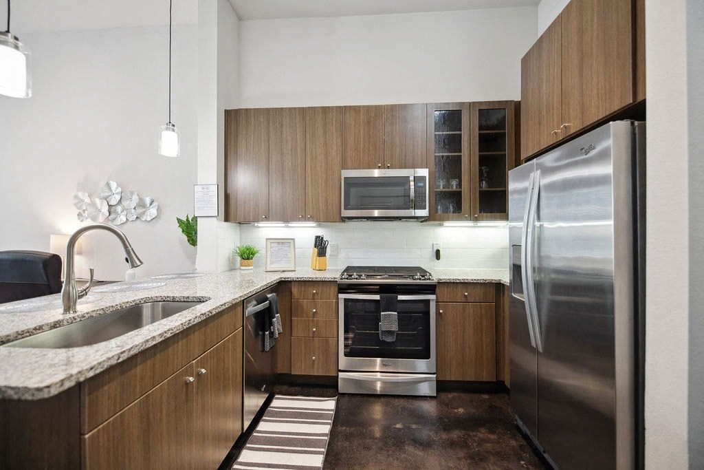 a kitchen with wooden cabinets and stainless steel appliances