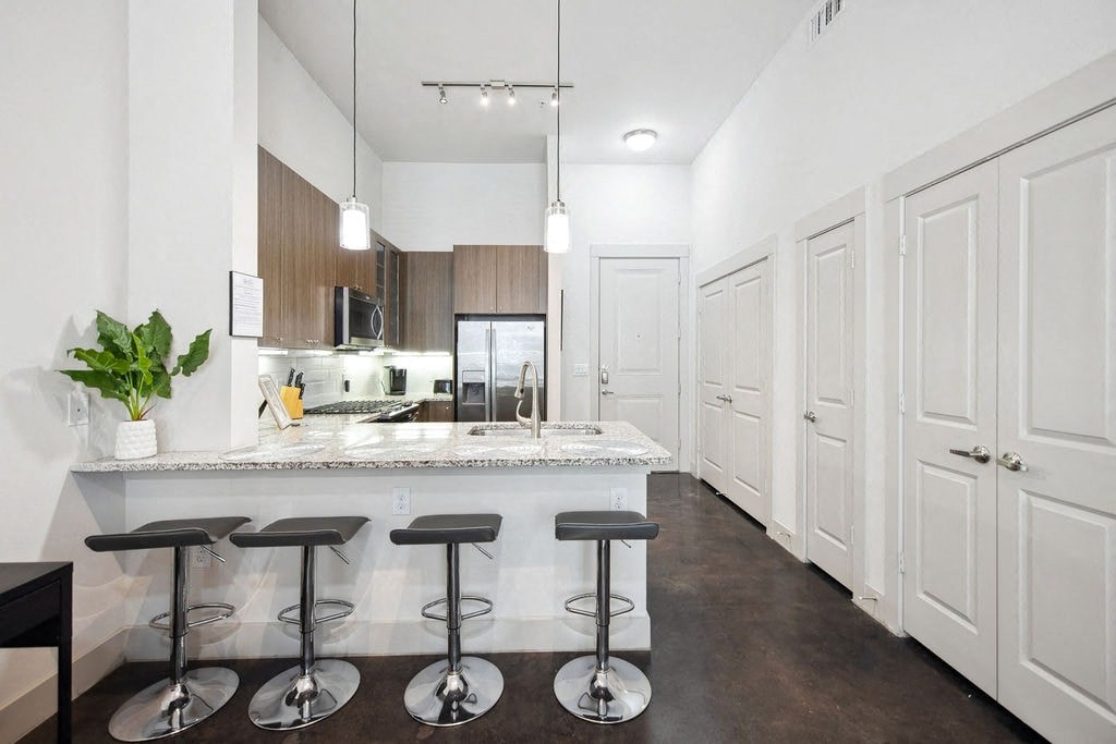 a kitchen with a counter top and stools