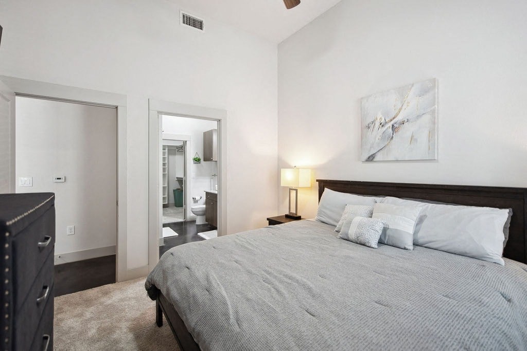 a bedroom with a bed and a door to a bathroom