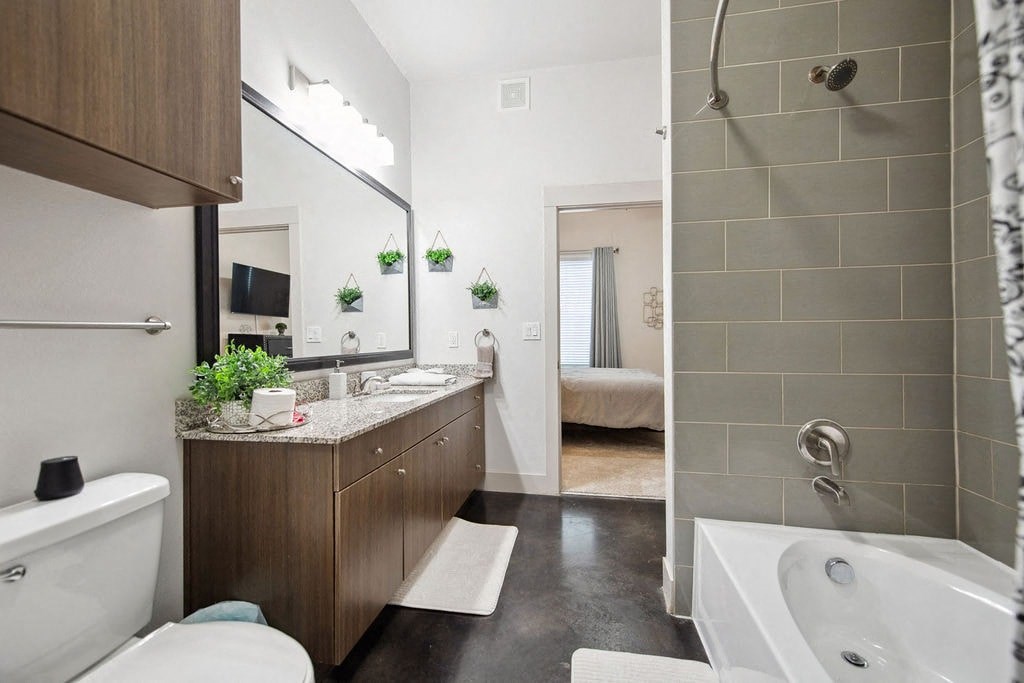a bathroom with a sink and a toilet and a shower
