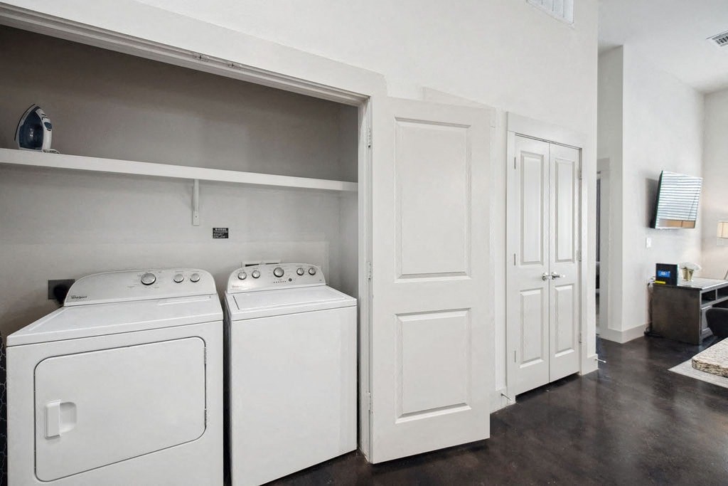 a white washer and dryer in a room next to a closet